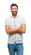 © Krakenimages.com - Adult hispanic man over isolated background happy face smiling with crossed arms looking at the camera. Positive person.