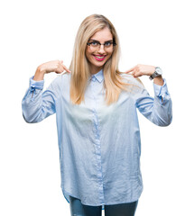 Poster - Young beautiful blonde business woman wearing glasses over isolated background looking confident with smile on face, pointing oneself with fingers proud and happy.