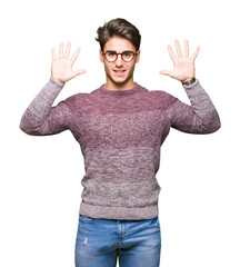 Young handsome man wearing glasses over isolated background showing and pointing up with fingers number ten while smiling confident and happy.