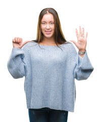 Young beautiful caucasian woman wearing winter sweater over isolated background showing and pointing up with fingers number six while smiling confident and happy.