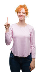 Poster - Young redhead woman showing and pointing up with finger number one while smiling confident and happy.