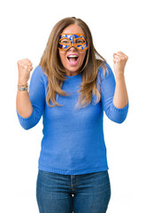 Sticker - Beautiful middle age woman wearing venice carnival mask over isolated background celebrating surprised and amazed for success with arms raised and open eyes. Winner concept.