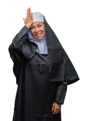 Poster - Middle age senior christian catholic nun woman over isolated background surprised with hand on head for mistake, remember error. Forgot, bad memory concept.