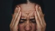 © Pniuntg - Closeup of a person's hands gripping their temples in intense headache pain, discomfort, neurological issue