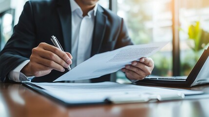 close-up of an asian male car salesman or sales manager explaining and reading the terms of a car co