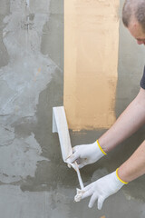 Wall Mural - A man is painting a wall with a brush