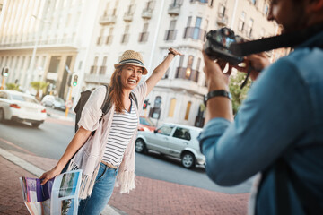 Poster - Celebration, photograph and travel with couple in city together for adventure, journey or success. Arm raised, honeymoon and smile of woman with man in urban town for bonding, holiday or vacation