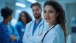 © jodoto - Female Doctor with Medical Team in Discussion - A friendly female doctor smiles confidently while engaging in a discussion with her medical team, showcasing a collaborative healthcare environment.