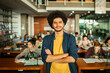 © Marko Geber - Portrait of a confident male student in university library with classmates studying in background