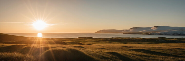 Wall Mural - Sun sets over peaceful Scandinavian coast, casting golden light on rolling green hills. Panoramic view, horizontal banner