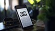 © TensorSpark - Smartphone displaying 'fact check' text, emphasizing the importance of verifying information.
