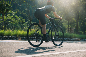 Wall Mural - Woman cyclist riding bike at summer park