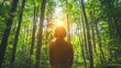 Person meditating in a sunlit forest, symbolizing the tranquility and healing aspects of forest bathing and ecotherapy.