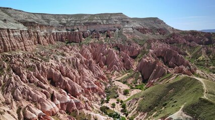 Wall Mural - Aerial footage of the scenic Rose Valley on a sunny day in Cappadocia, Turkiye