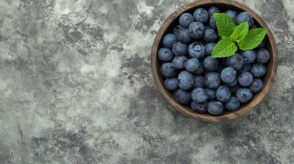 Wall Mural - Fresh Blueberry with Vanilla Mint in a Rustic Wooden Bowl on Stone Background, Top View