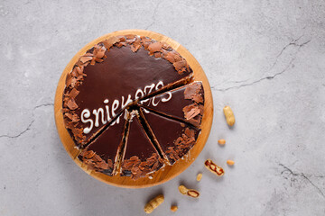 Wall Mural - Snickers cake with caramel, peanuts and buttercream.