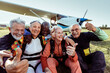 © Marko Geber - Diverse senior people taking group selfie before skydiving