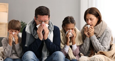 Canvas Print - Cold symptom. Family suffering from fever on sofa at home