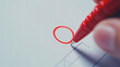 © Kiron - Focused image of a red pen circling a crucial point on a safety checklist, clean white background,. Ai generated