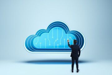 Poster - Businessman interacting with a large digital cloud icon on a blue background.