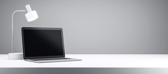 Laptop and desk lamp on a white desk with grey background. 3D Rendering