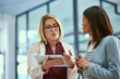© SensSai/peopleimages.com - Advice, discussion and women in business with tablet, opinion or team with project management proposal. Online report, plan and mentor with employee, digital app or collaboration at creative agency