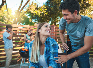 Canvas Print - Beer, laughing and smile with couple at party together for barbecue, celebration or fun in summer. Alcohol, bottle or love with happy man and woman in backyard of home for bonding or social gathering