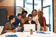 © peopleimages.com - Business, mentor and group with learning on laptop for induction training, onboarding and company orientation. Intern diversity, people and HR manager with tech for introduction to sales work process