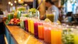 © buraratn - A fresh juice bar counter with various colorful smoothies, highlighting healthy beverage choices.
