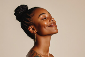 A close up of a tattooed black woman's face with her eyes closed