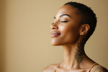 A close up of a tattooed black woman's face with her eyes closed