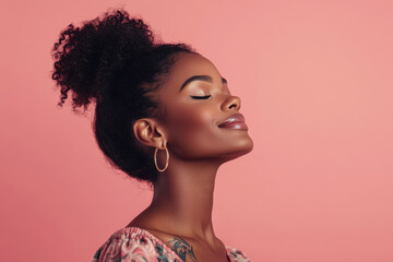 A close up of a tattooed black woman's face with her eyes closed