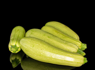 Several ripe zucchini, macro, isolated on black background.