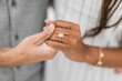 © Studio95 - woman and man holding hands while displaying their proposal diamond ring