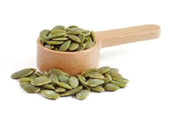 Pumpkin seeds close up on white background.