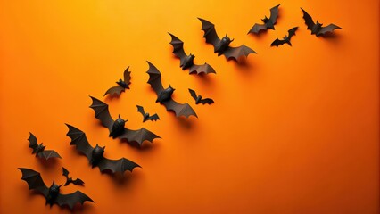 Black paper bats flying against a bright orange background, Halloween, spooky, decorations, creepy, bats, cutouts, silhouette