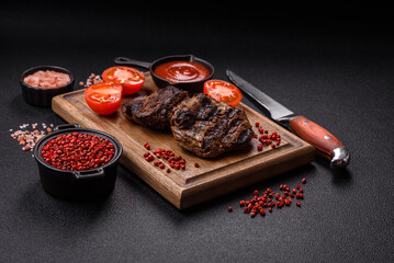 Fresh juicy delicious beef steak on a dark background