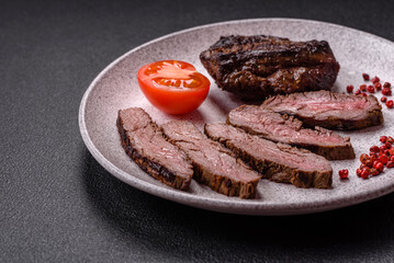 Fresh juicy delicious beef steak on a dark background