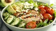 © Murda - Grilled chicken salad with avocado, tomatoes, and cucumbers.