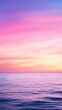 © kanoktuch - Soft pastel sunset over the calm ocean, with gentle hues of pink, purple, and blue blending in the sky. The tranquil scene captures the serene beauty of nature.