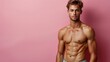 © Светлана Гуркова - Young man posing confidently against a pink background with a toned physique and casual swimwear