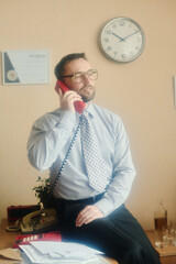 Poster - Man in office holding phone to ear with certificate and clock on wall displaying business environment