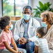 © Tekin - African American doctor talking to extended family at medical clinic during coronavirus pandemic.