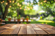 © maribom - Summer time party in backyard with empty wooden table and blurred background