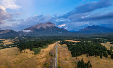 Wall Mural - Scenic Road in Mountain Valley, Canadian Countryside. Aerial Sunrise. Alberta, Canada