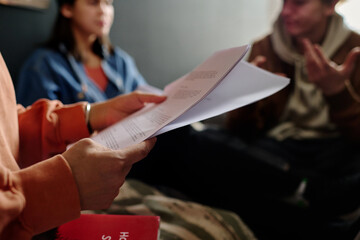 Poster - Group of individuals reviewing important document in comfortable setting, engaging in lively discussion. Paperwork and casual attire suggest relaxed yet focused atmosphere