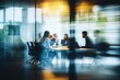 © 为轩 张 - Business team collaborating around a table in a modern office, captured through glass walls, planning for success with a blurred effect that adds dynamic movement, emphasizing teamwork and strategy.