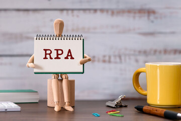 Poster - There is notebook with the word RPA. It is an abbreviation for Robotic Process Automation as eye-catching image.