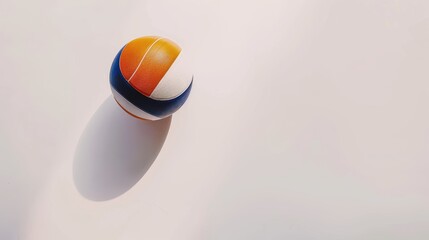 Volleyball ball casting a shadow on a white background in sunlight, with room for text