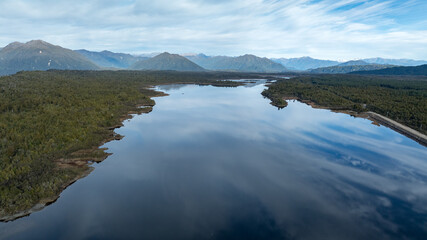 Wall Mural - Remote Kapitea Reservoir reflections surrounded by mountain ranges , near Kumara West Coast NZ